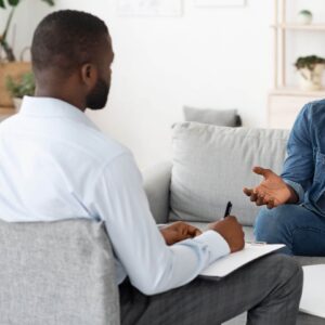 A Fort Worth trauma therapist listens attentively as a client discusses their experiences during a session, exemplifying the importance of trauma therapy in Fort Worth.